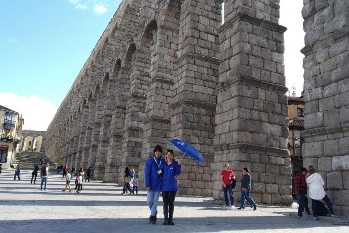 a group of people walking in front of a building