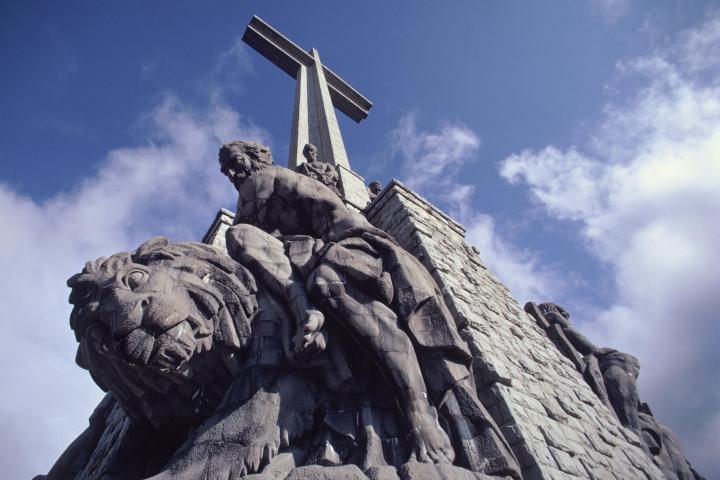 a statue of a large rock with Marine Corps War Memorial in the background