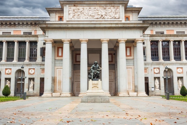 a large stone building with Museo del Prado in the background