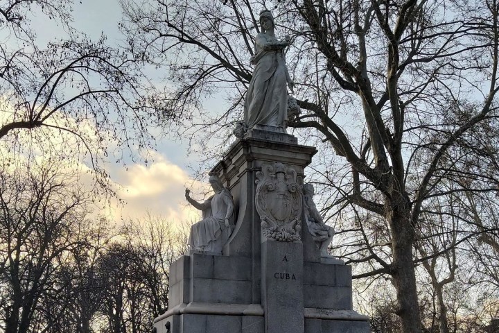 a tall clock tower sitting under a tree