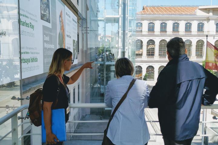 a group of people walking on a city street