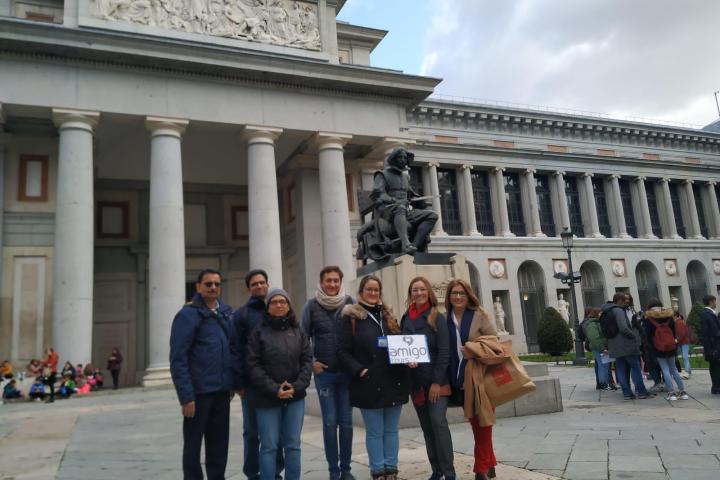a group of people walking in front of a building