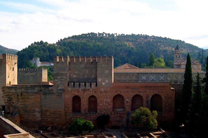 a castle like building with a mountain in the background