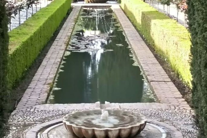 a path with trees on the side of a building