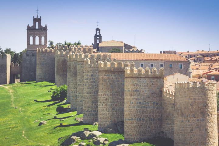 a stone castle next to a brick building