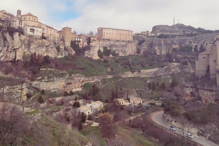 a large stone building with a mountain in the background