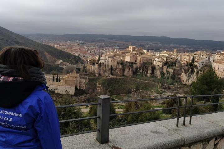 a person sitting on a bench in front of a mountain