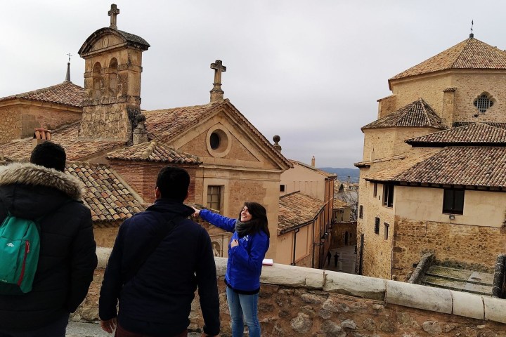 a group of people standing in front of a stone building