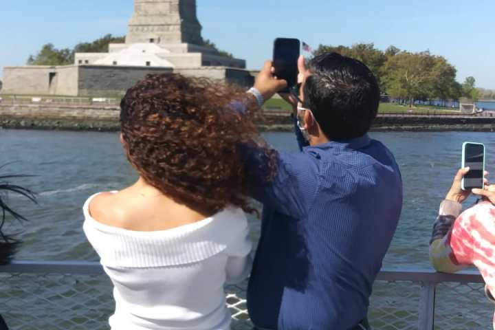 a man and a woman standing in front of water
