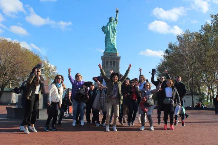 a group of people standing in front of a crowd posing for the camera