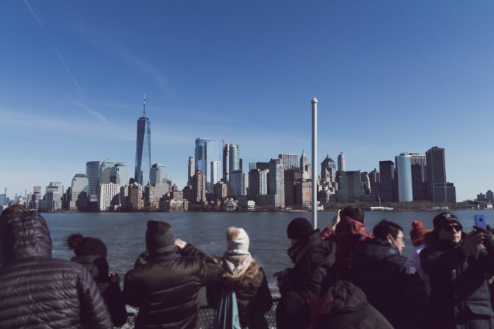 a group of people standing next to a body of water