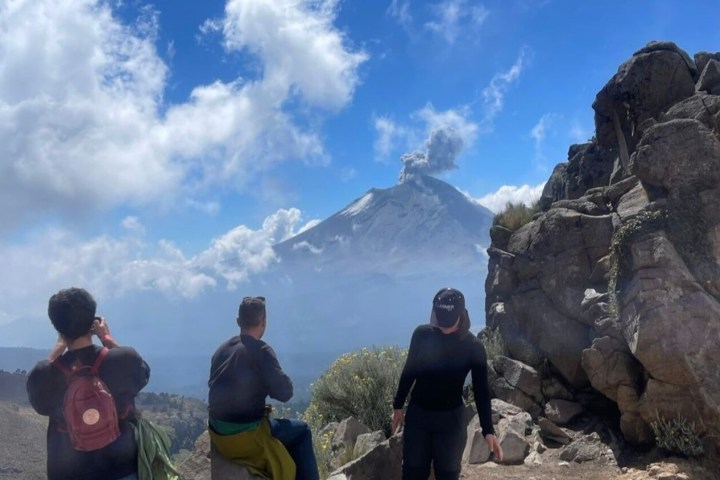 a group of people standing on a rock