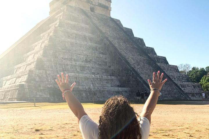 a person standing in front of a mountain