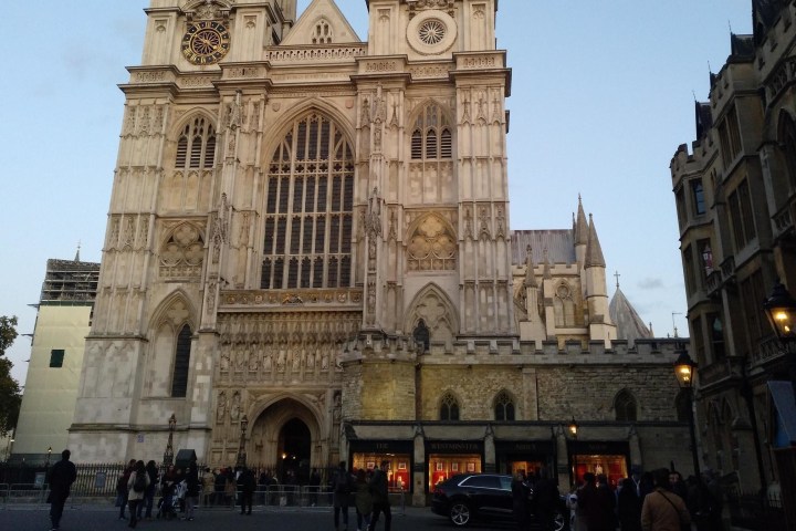a church with a large clock tower in front of a building