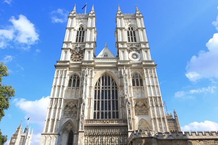 a large tall tower with a clock at the top of Westminster Abbey