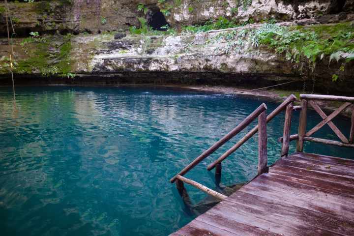 a wooden bench sitting next to a body of water