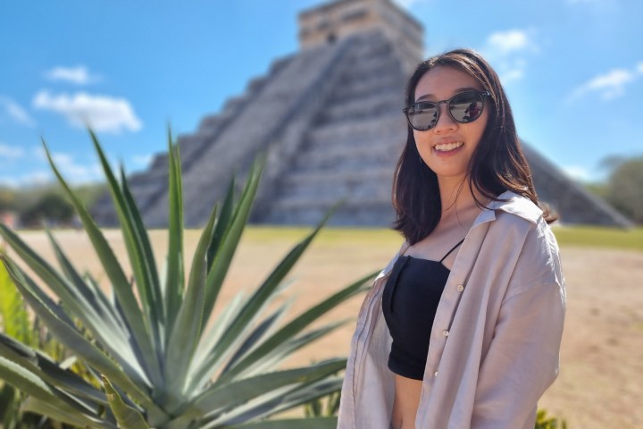 a woman wearing sunglasses posing for the camera