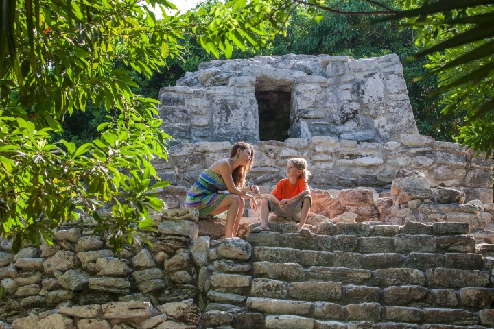 a stone building that has a fence in front of a brick wall