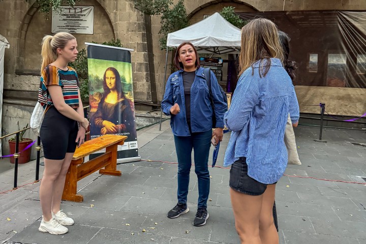 Mona Lisa et al. standing in front of a building