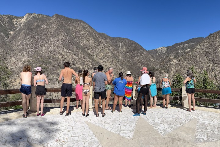 a group of people standing on top of a mountain