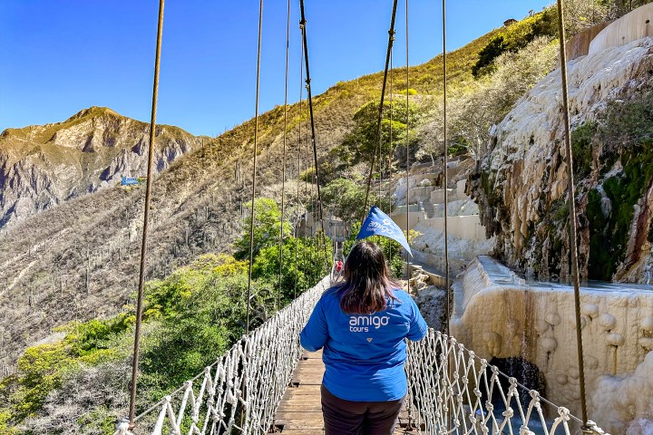 a person standing in front of a mountain
