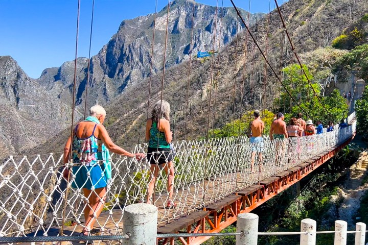 a group of people standing in front of a fence