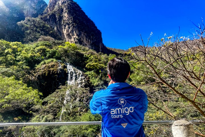 a man standing in front of a mountain