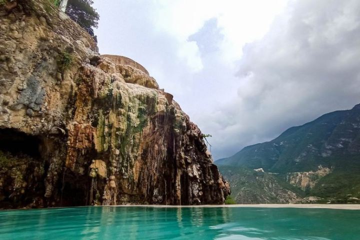 a large body of water with a mountain in the background