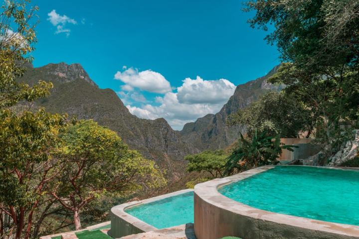 a pool with a mountain in the background