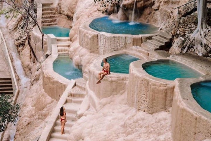 a pool next to a stone wall