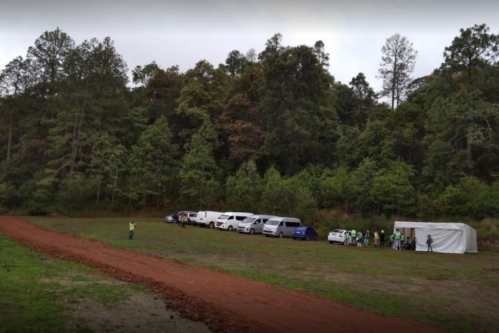 a bus traveling down a dirt road
