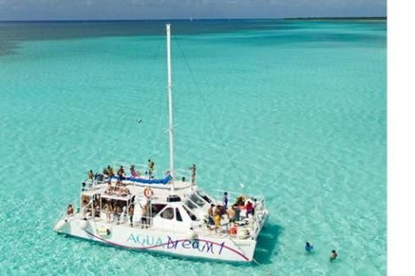 a blue and white boat sitting next to a body of water