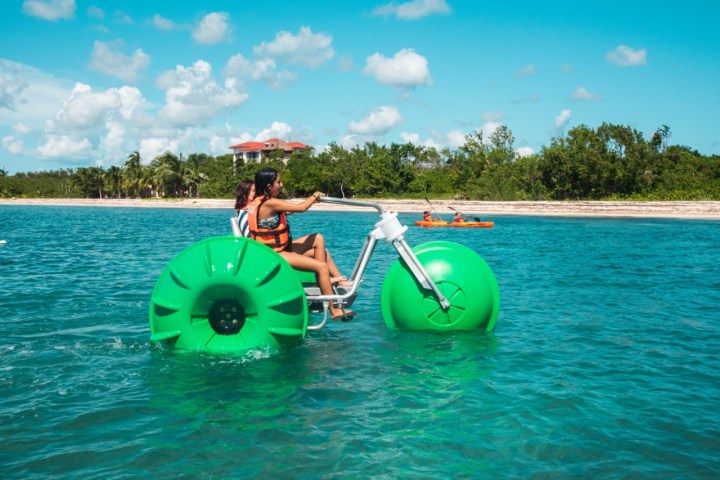 a man in a green boat on a body of water
