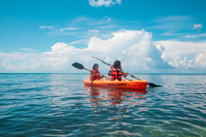 a man riding on the back of a boat in a body of water