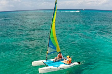 a man riding on the back of a boat in a body of water