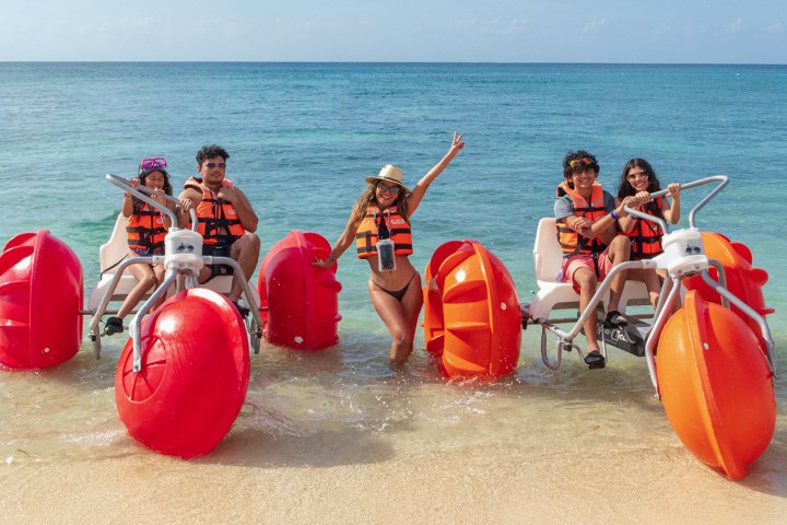 a group of people sitting at a beach