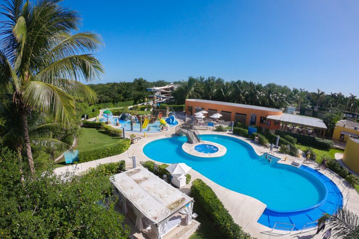 a large lawn in front of a pool