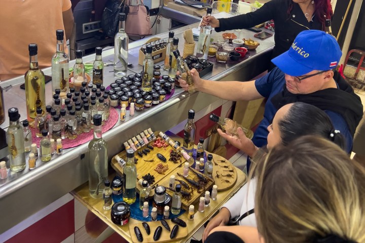 a group of people looking at a birthday cake