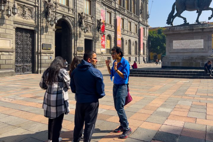 a statue of a man and a woman walking down a sidewalk