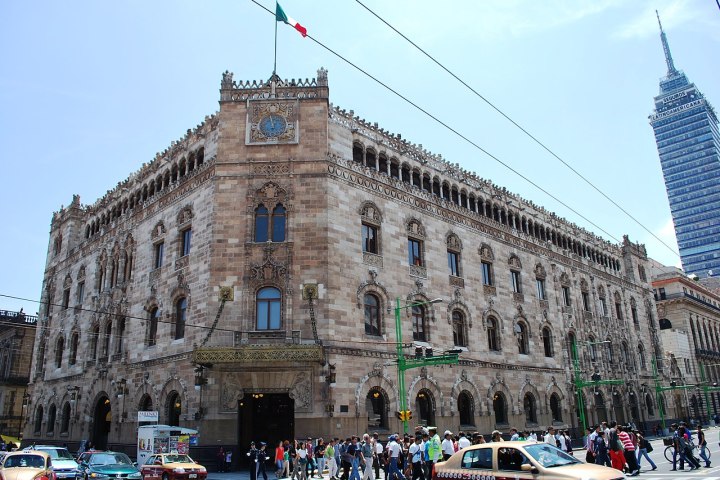 a group of people walking in front of a building