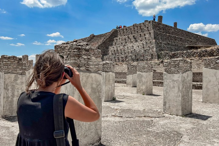a person standing in front of a rock