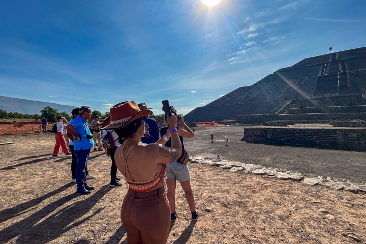a group of people walking down a dirt road