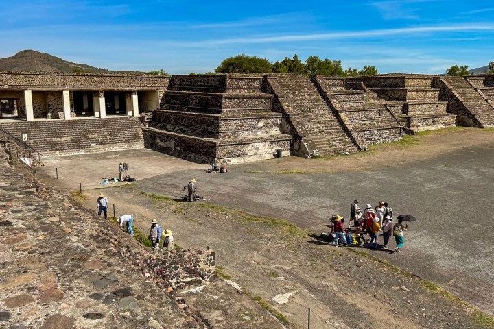 a group of people sitting on the side of a building