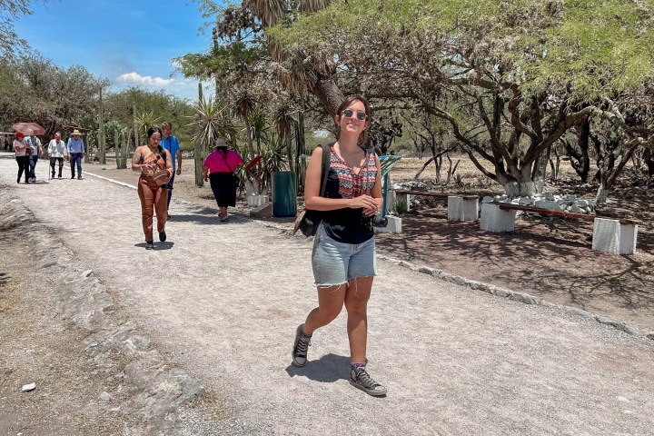 a group of people walking down a dirt road
