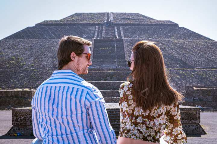 a person standing in front of a mountain