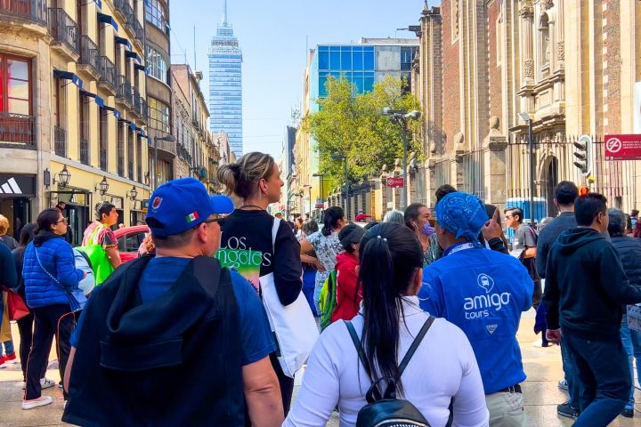 a group of people walking on a city street