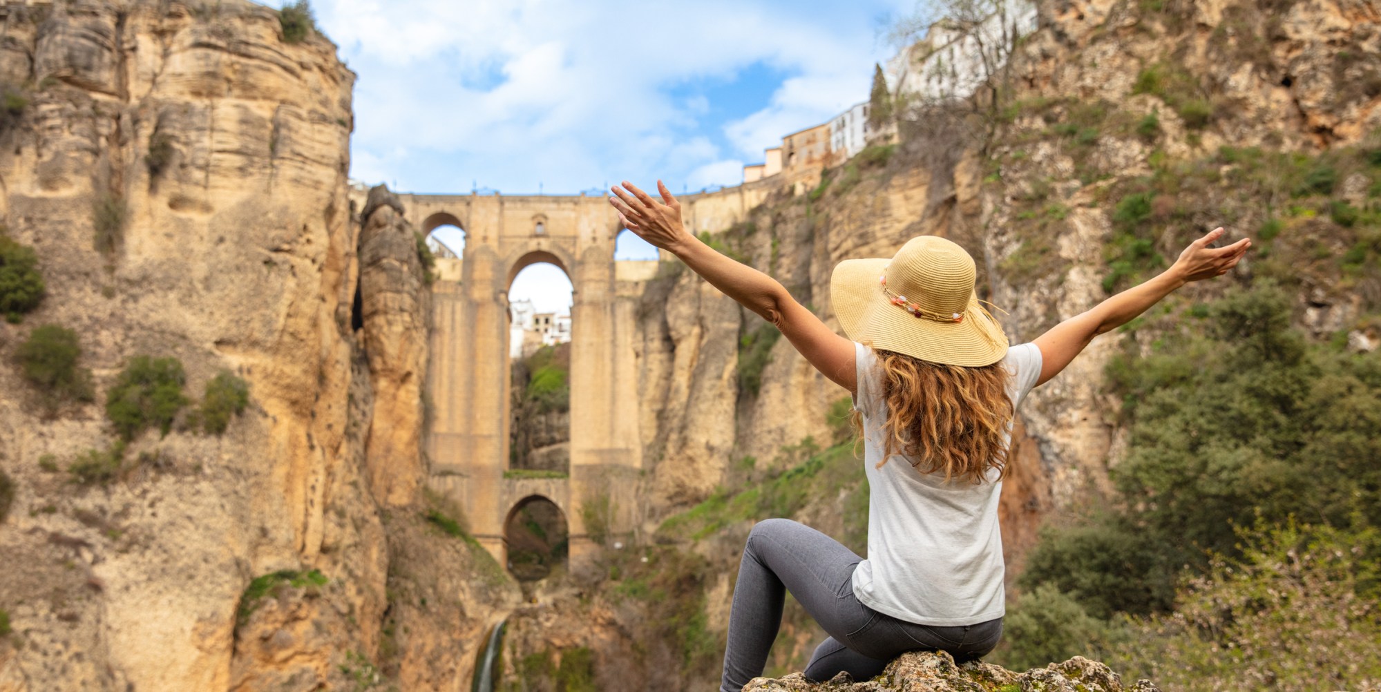 woman travel in Spain- Andalusia, city of Ronda a person doing a trick on a rock