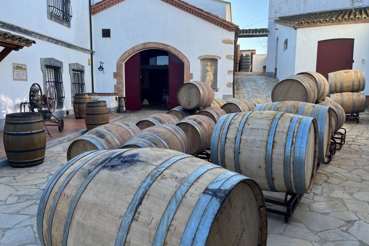 a barrel sitting next to a brick building