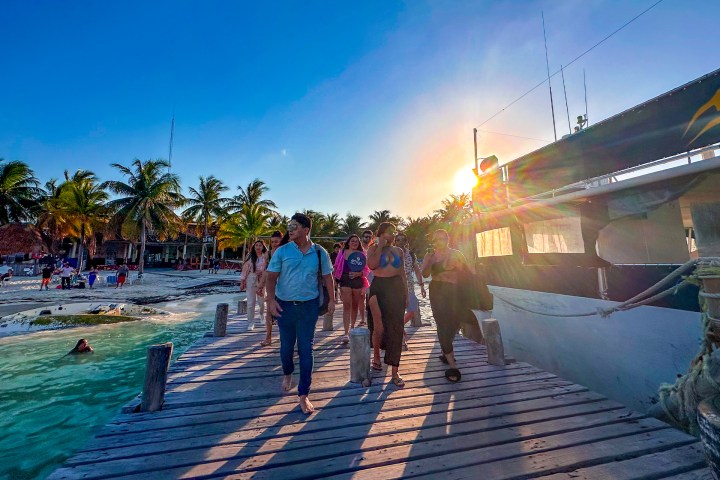 a group of people walking on a pier