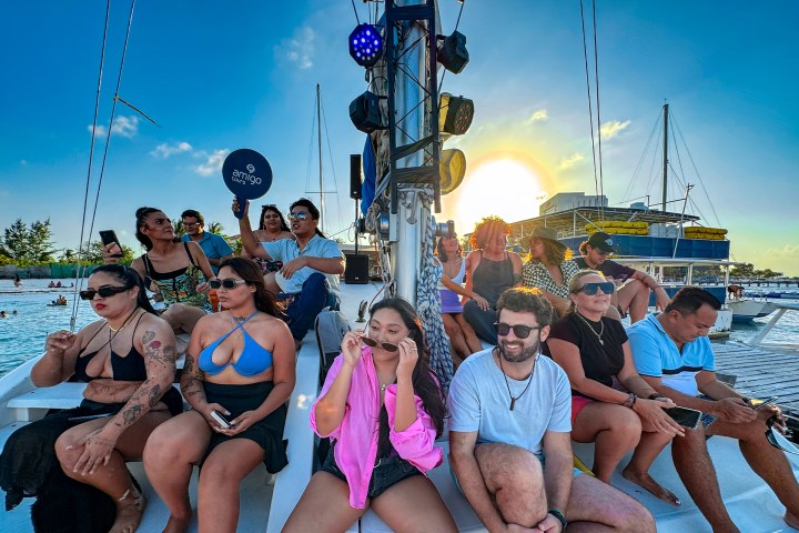 a group of people sitting on a boat posing for the camera